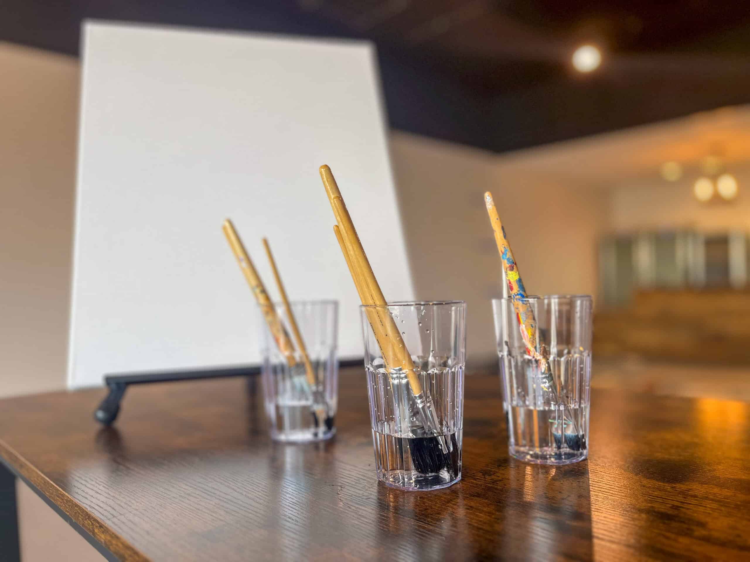 Empty painting canvas and brushes