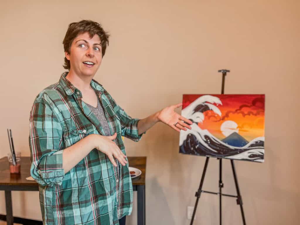 Laura teaching a sunset and waves painting